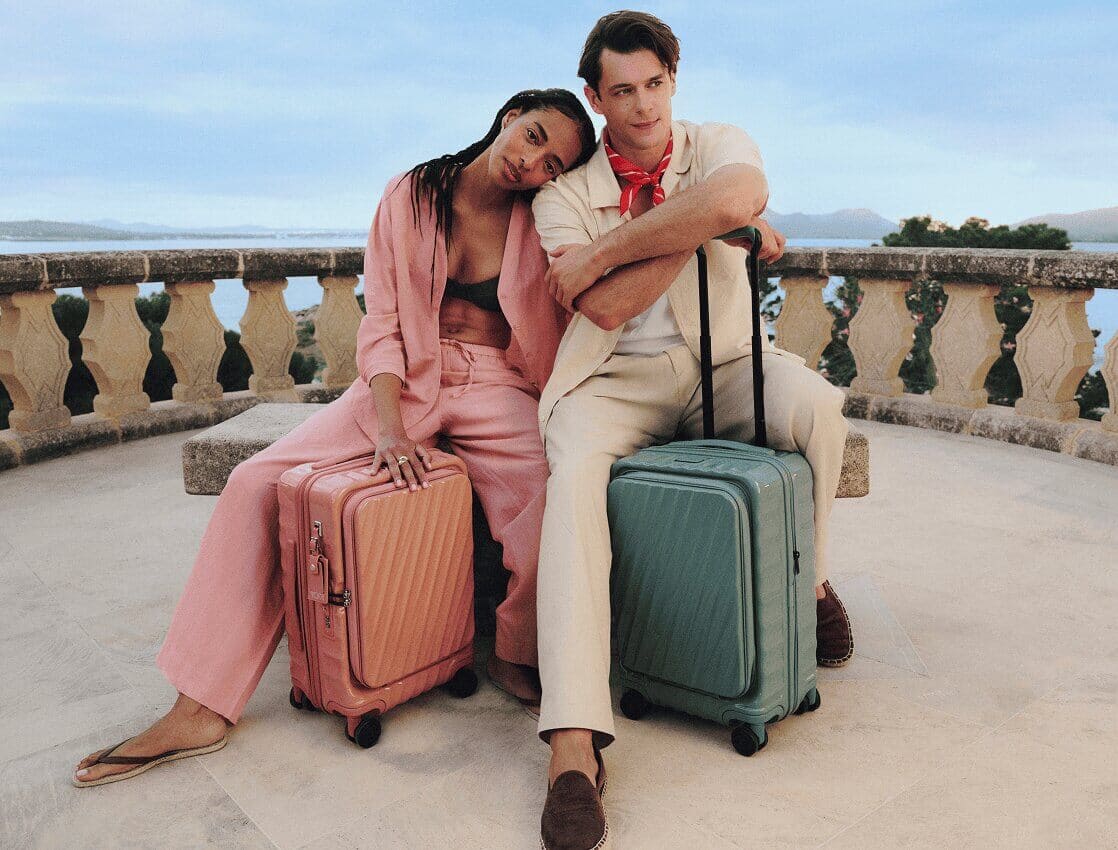 Couple seated with luggage